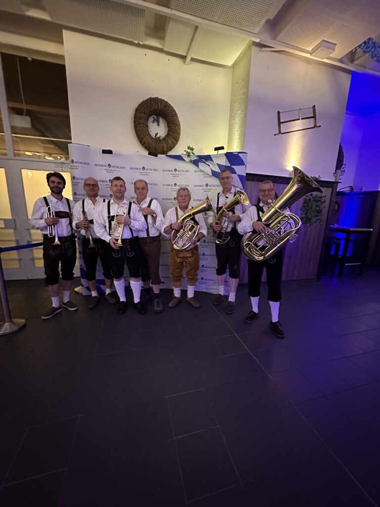 Oktoberfest brass band performing Bavarian music at construction site opening in Rangsdorf